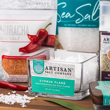 Artisan Salt Company® salts and Fusion® flavored salts arranged on a table