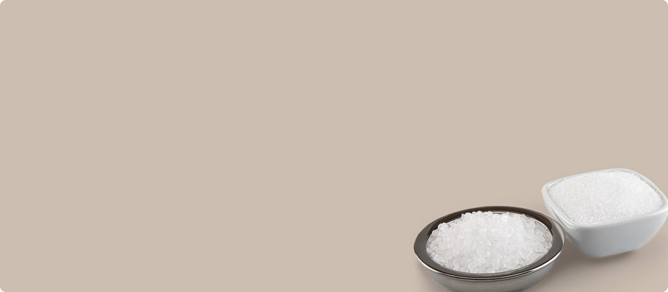 Two small containers of salt on a beige background