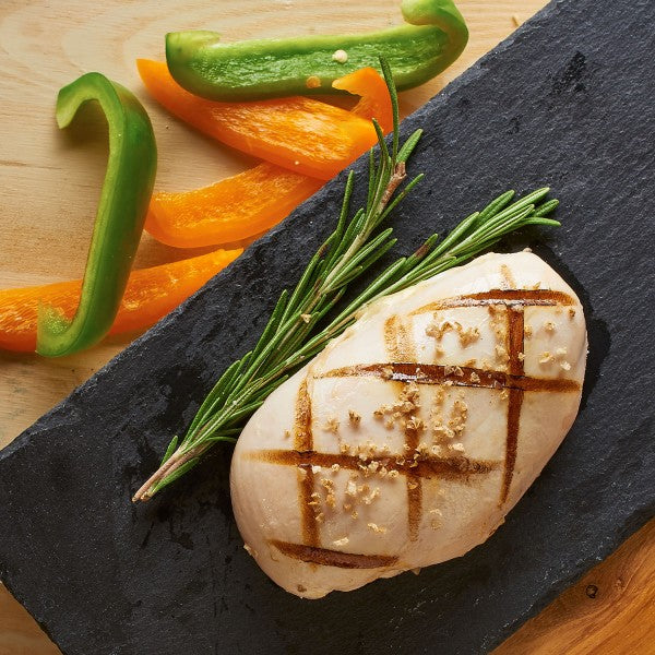 Grilled chicken with grilled vegetables on a slate board