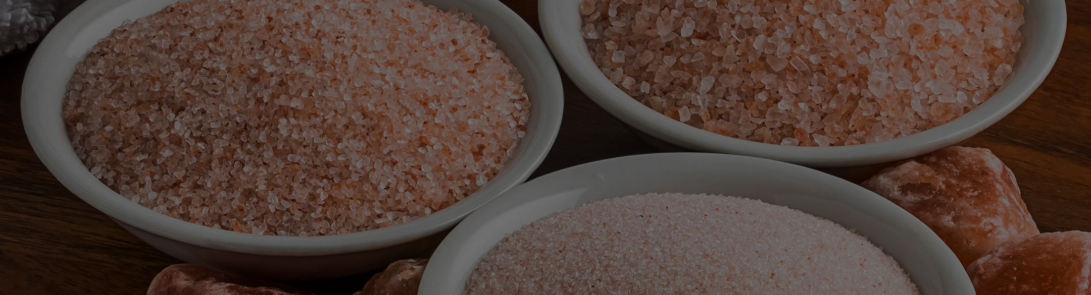 Three bowls of Himalayan Salt on a wooden surface