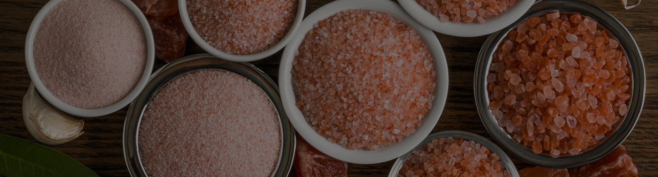 Bowls of Himalayan salt on a wooden surface