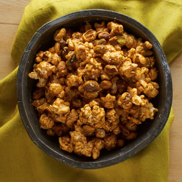 Bowl of caramel popcorn on a yellow cloth