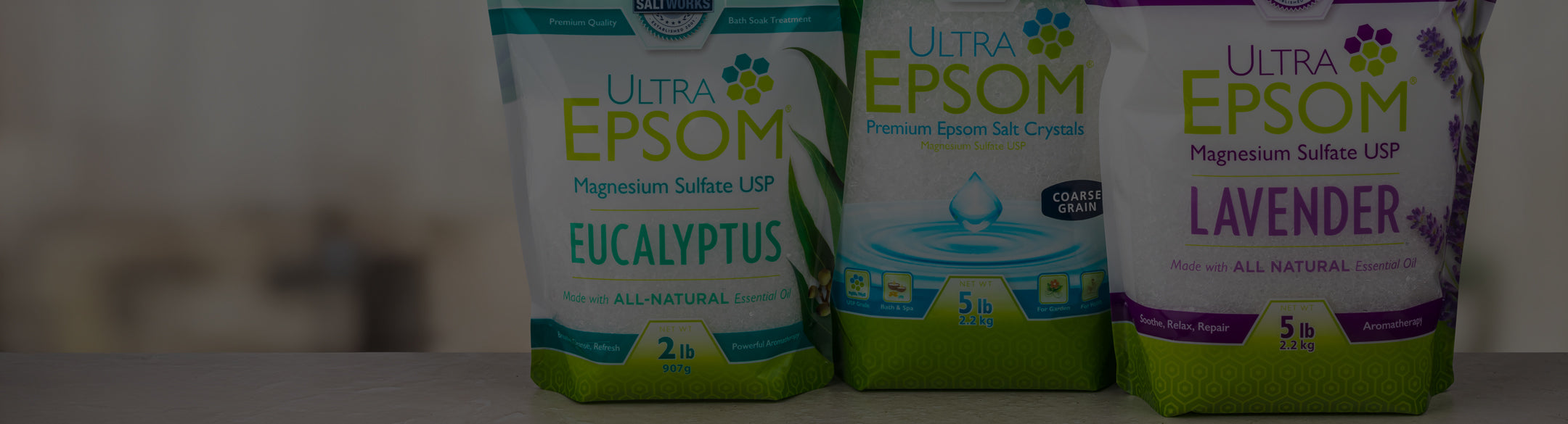 Three bags of Ultra Epsom salts with different scents on a blurred background