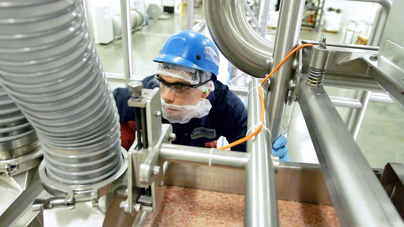 Man using machine filled with Himalayan salt